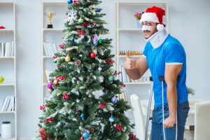 Man who just had an accident in front of the Christmas tree