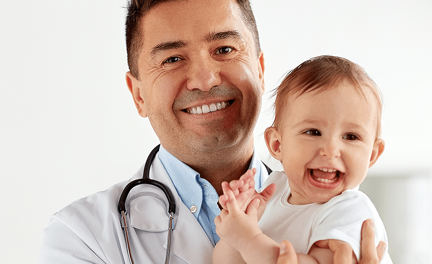 doctor holding a happy baby
