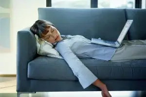 Person experiencing fatigue and low energy at home in St. Louis