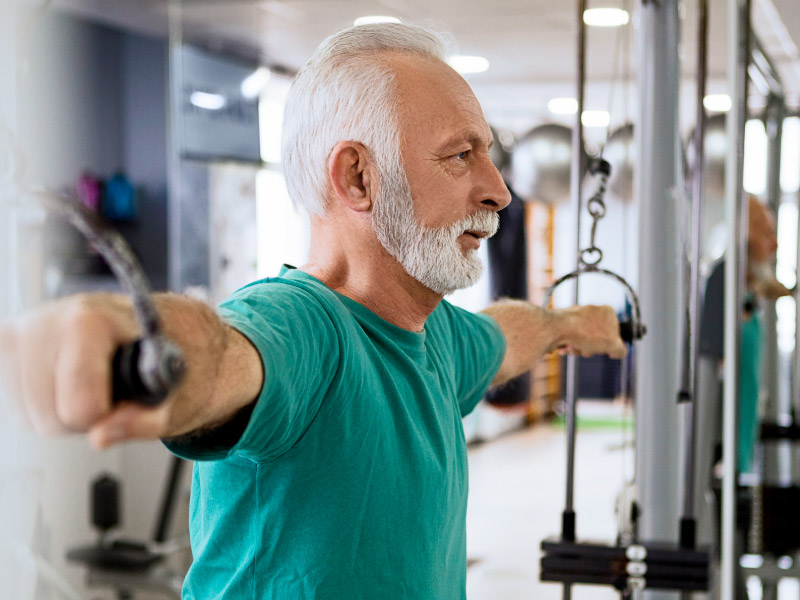 Man over age 50 working out after having talked with his physician to discuss testosterone testing and preventive health.