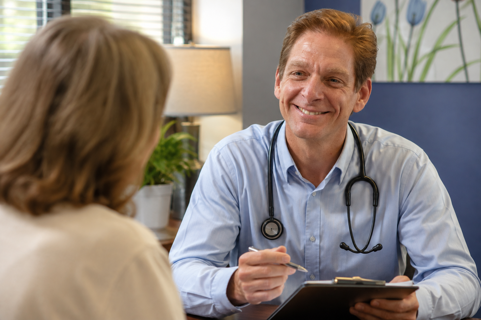 Dr. Jeffrey Davis speaking with a patient during a relaxed Direct Primary Care visit at Link Primary Care in St. Louis.