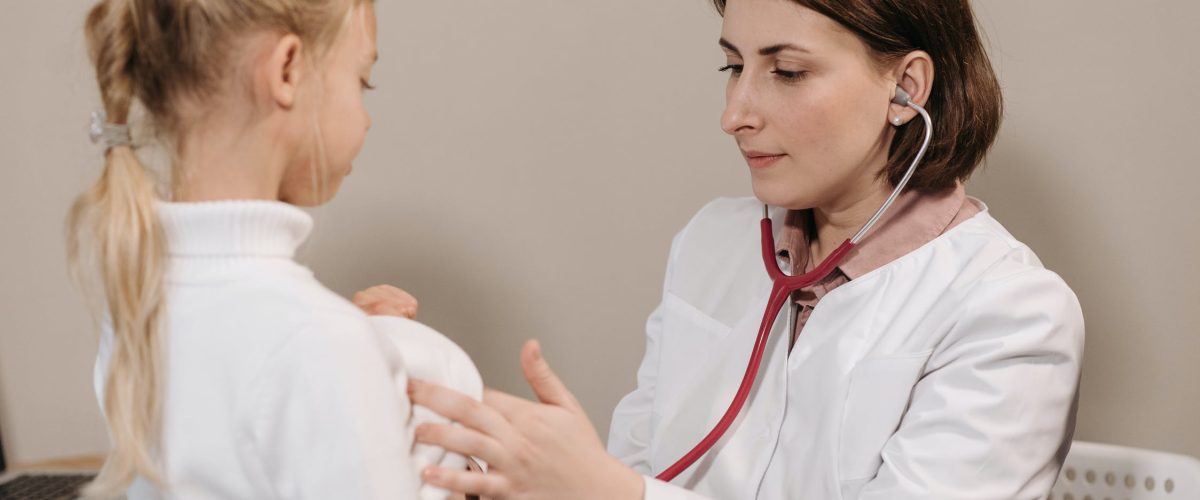 Doctor in White Lab Coat Examining Girl's Breath
